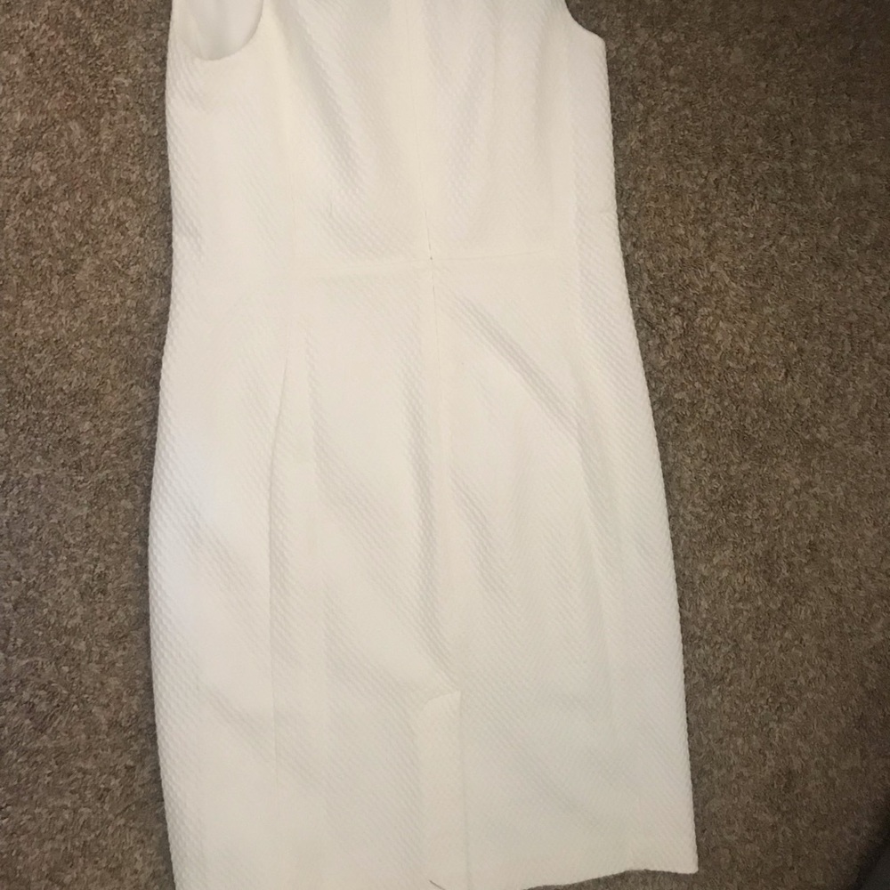 White dress , v neck, lining, above knee, textured material opens from the back
